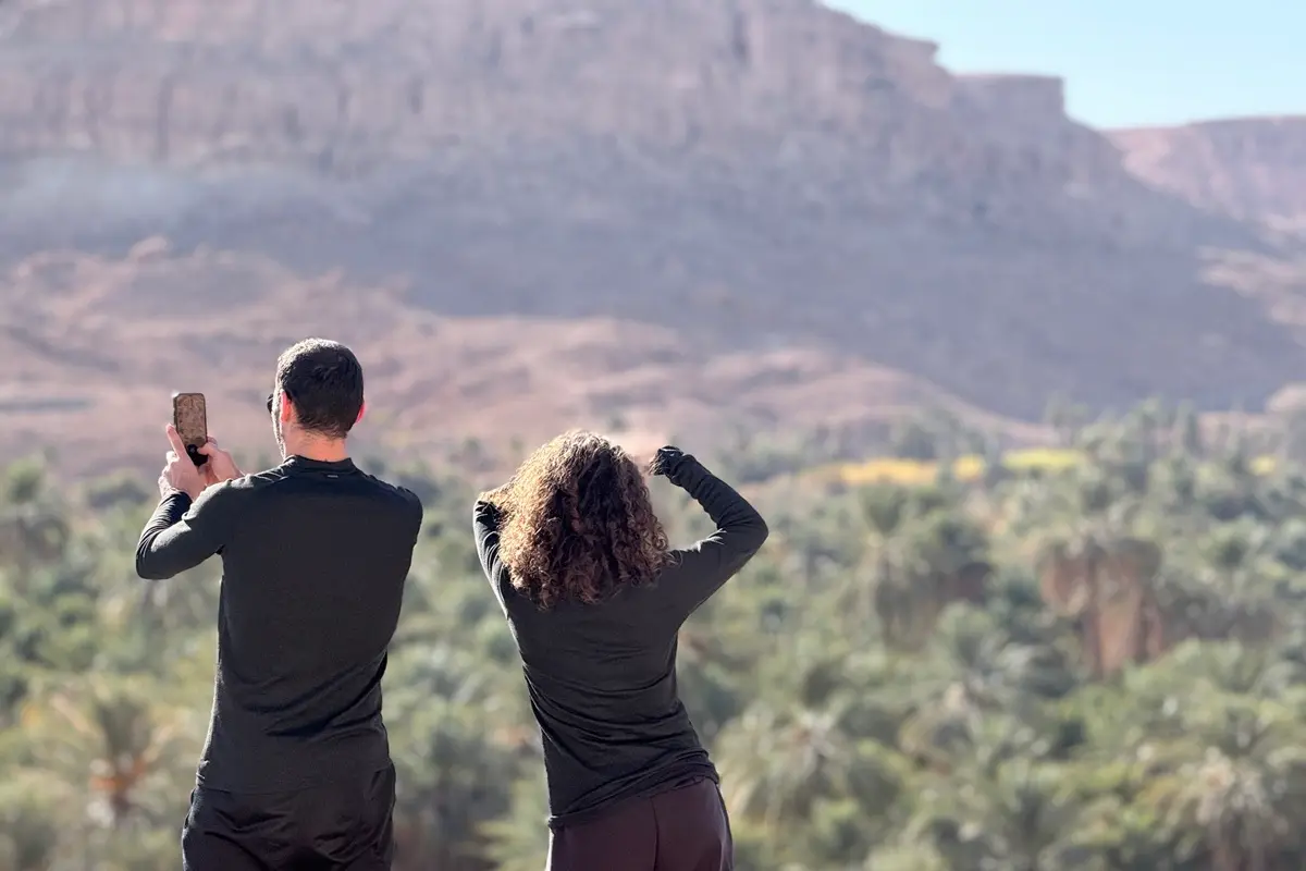 Travelers enjoying the panoramic view of Ziz Valley during a 2-day Fes to Merzouga desert tour