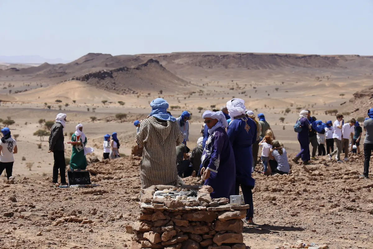 Travelers exploring the fossil quarry near Erfoud during a Morocco desert tour